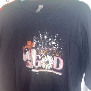 A large, black, “I’m just trusting God” woman’s t-shirt.